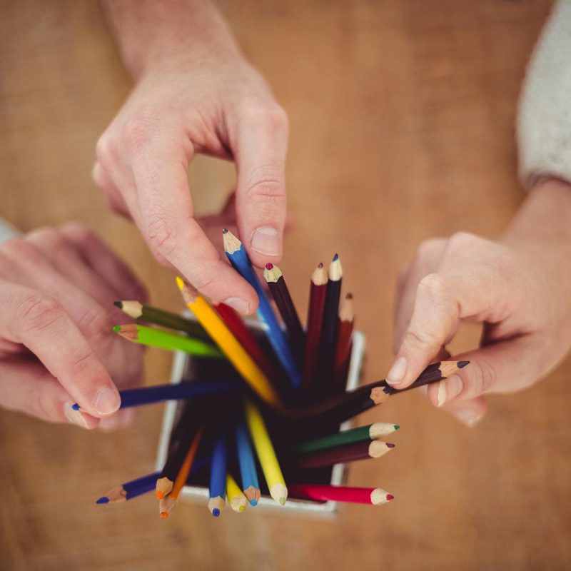 creative-team-choosing-different-coloured-pencils-PMSUVPX.jpg